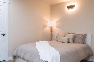 a bedroom with a bed with a lamp on it at Beautiful place with a great location, free parking, WiFi & large TV. in Federal Way