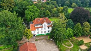 an aerial view of a large white house in a forest at Haus am Walde in Bad Fallingbostel
