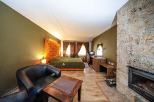 a hotel room with a bed and a fireplace at Hotel Çarshia e Jupave in Gjakove