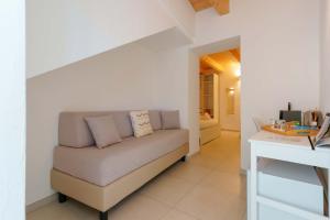 a living room with a couch and a table at TS ROOMS - Guest House Sciola in San Sperate