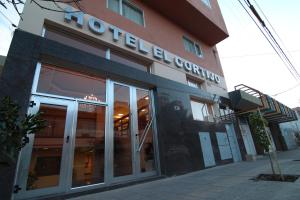 a building with a sign on the side of it at Hotel El Cortijo in Neuquén