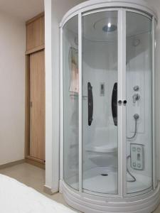 a shower with a glass door in a room at Hotel Valledupar Plaza in Valledupar