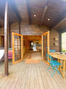 a wooden cabin with a table and chairs on a deck at Vale do Laranjal in Setúbal +24 photos
