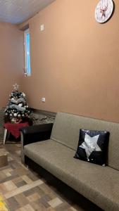 a living room with a couch and a christmas tree at Nova Montan Azuga in Azuga