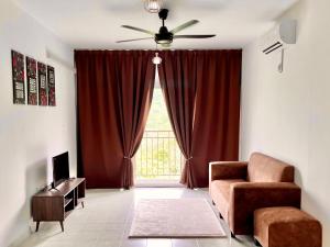 a living room with a couch and a window at Omak Kito Homestay Melaka in Kampong Alor Gajah