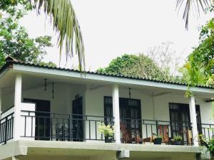 a house with a balcony with plants on it at Midira Villa in Galle