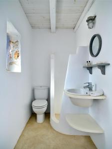 a white bathroom with a toilet and a sink at Cycladic Villa, Blue Stories in Santa Marina +41 photos
