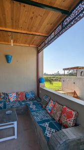 a room with a couch and pillows on a roof at Yasmine Guest House in Luxor