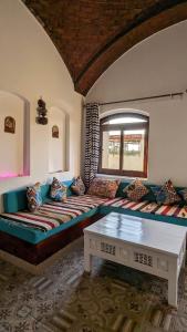a living room with a couch and a window at Yasmine Guest House in Luxor