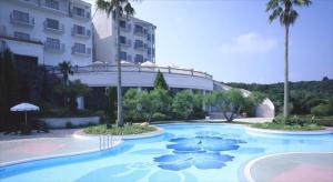 a large swimming pool in front of a building at Hotel Shima Spain Mura in Shima