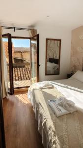 a bedroom with a bed and a view of a balcony at Casón De Los López Apartments in Toledo +193 photos