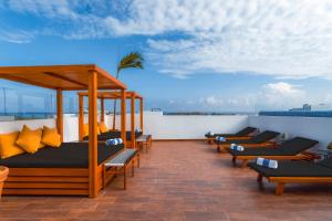 a row of beds on the roof of a building at Terrasse Hotel Playa del Carmen in Playa del Carmen