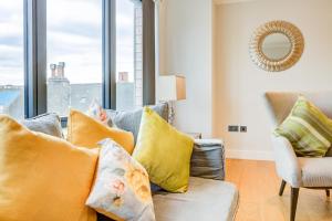 un soggiorno con divano e cuscini gialli di Concord House a Brentford