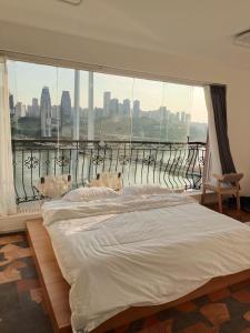 a bedroom with a white bed and a large window at Comacros - Chongqing JieFang Cave River View Apartment - Line 1 and Line 2 Jiachangkou Subway Station in Chongqing