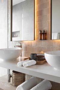 a bathroom with two sinks and a mirror at Escape to the Beach in Wilderness