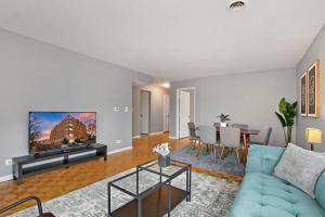 a living room with a blue couch and a table at Tranquil 2BR Escape in Ideal Location - Church 301 in Evanston