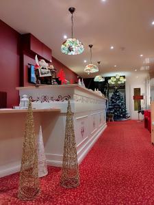 - un hall orné d'un arbre de Noël dans l'établissement Hôtel Restaurant Le Kastelberg, The Originals Boutique, à Andlau