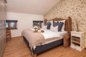 a bedroom with a large bed with flowers on it at MY STAY Erholung auf Erlebnishof zwischen Chiemseestrand und Kampenwand in Bernau am Chiemsee