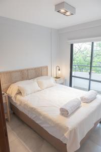 a bedroom with a large bed with two towels on it at Torre Alem 2 A in San Miguel de Tucumán
