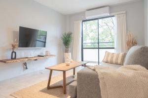 a living room with a couch and a table at Torre Alem 2 A in San Miguel de Tucumán
