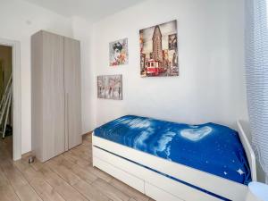 a bedroom with a bed and pictures on the wall at Happy House in Savona