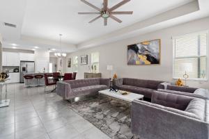 a living room with couches and a dining room at Luxurious Tampa Bay Area Home in Serene Community! in Riverview