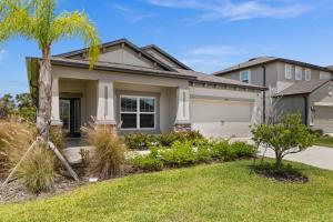 una casa con una palma di fronte di Luxurious Tampa Bay Area Home in Serene Community! a Riverview