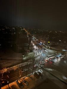 a city at night with cars parked on a street at VIP апартаменти ЦЕНТР in Rivne