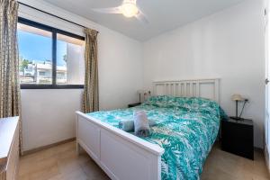 a bedroom with a bed with a blue comforter at Sea Views Torreoceano 7 in Mijas Costa +13 photos