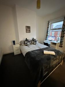 a bedroom with a large bed and a window at Lovely Town house Room 2 in Parkside