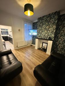 a living room with a couch and a fireplace at Lovely Town house Room 2 in Parkside