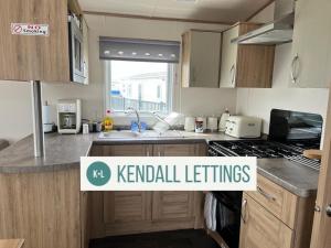 a kitchen with a sign that reads kennel settings at Oakley (West Sands) in Selsey