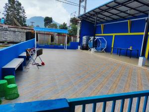 a view of a gym with a blue and yellow wall at Villa Brastagi Gunung Mas Blok A1 in Berastagi