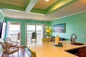 a living room with green walls and a table and chairs at Cool Breeze - Sunset views like no other in Tampa