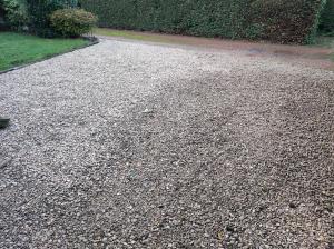 a gravel driveway with a path in a garden at Gite du Moulin in Oignies