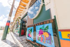 a building with a painting of a unicorn on the side of it at NOMADA HOTEL GUATAPE in Guatapé