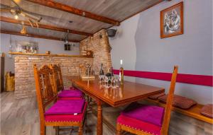 un comedor con mesa de madera y sillas con cojines morados en Beautiful Apartment In Cavle With Wi-fi, en Čavle
