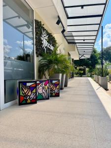 a building with stained glass panels on the sidewalk at Hotel TACALOA INN EXPERIENCE in Ricaurte