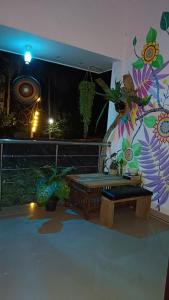 a room with a bench and a wall with plants at Kailani boutique stay in Varkala