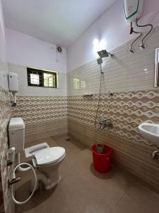 a bathroom with a toilet and a sink at Kailani boutique stay in Varkala