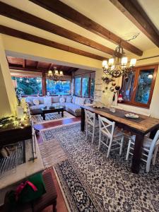 a living room with a table and a couch at Livadi cozy villa in Arachova