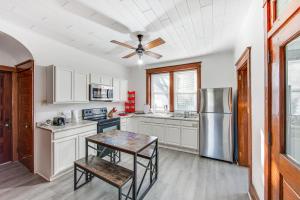 a kitchen with white cabinets and a ceiling fan at Lovely Lancaster Studio in Walkable Location! in Lancaster