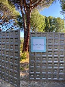 a sign on a fence with a tree in the background at Casa Valdesanmartin - Country House, 10500sqm, Pool, Paddel & Bbq in El Tiemblo
