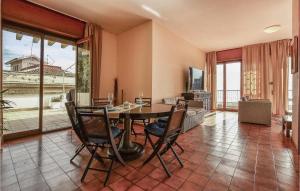 a dining room with a table and chairs at Stunning Apartment In Aci Castello With Kitchen in Aci Castello