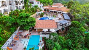 an aerial view of a resort with a swimming pool at Shana by the Beach Manuel Antonio in Manuel Antonio