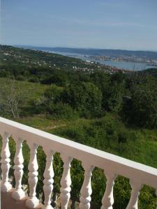 a white balcony with a view of the water at Apartment Mara in Ankaran