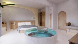 a hotel room with a tub in the middle of a bedroom at Unsal Hotel in Oludeniz
