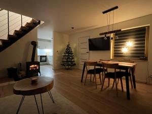 a living room with a table and a christmas tree at Domek pod Magurką in Międzybrodzie Bialskie