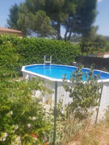 a swimming pool in a garden with a fence at Maison de 4 chambres avec piscine privee et jardin clos a Aubenas a 1 km de la plage in Aubenas