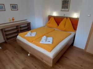 a bedroom with a bed with two towels on it at Apartment Rupertus-2 by Interhome in Maishofen